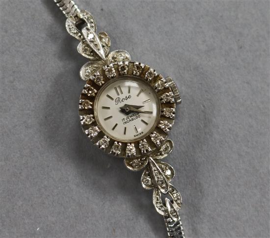 A ladys 18ct white gold and diamond set Rose cocktail watch, on a 9ct white gold snakelink bracelet.